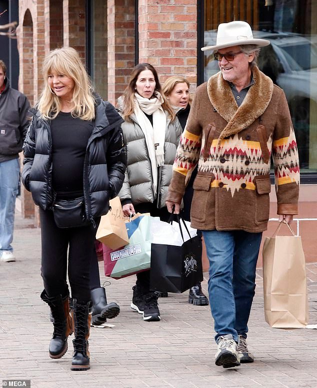 Kurt looked ready for winter with a double-breasted brown wool overcoat with furry shawl lapel, along with blue jeans and taupe hiking shoes