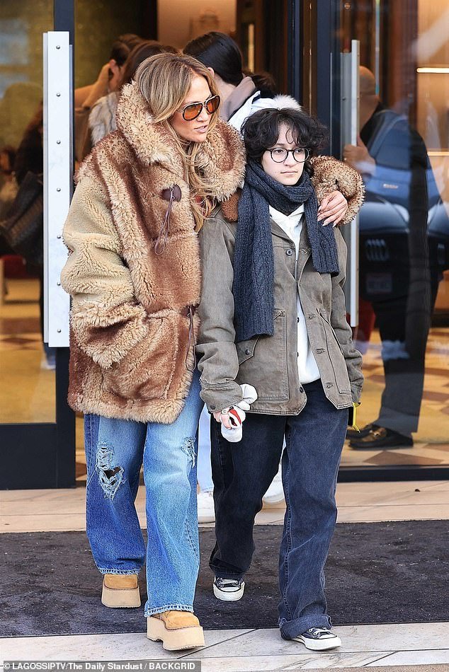 Jennifer looked warm and cozy as she emerged from a Gucci store wearing a thick, furry brown coat with a tall popped collar while putting an arm around Emme