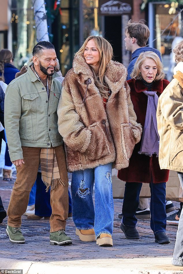 Her mother Guadalupe showed off her Christmas spirit with a fuzzy red coat, while manager Benny Medina rocked a timeless olive-colored Levi's trucker jacket