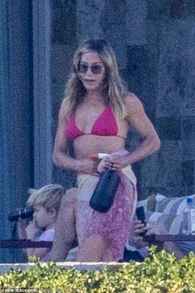 She rocked sunglasses with her caramel highlighted locks loose around her for a low-key vacation look