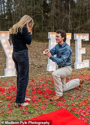 Jordan got down on one knee to pop wearing a blue denim shirt, tan pants and brown Western boots