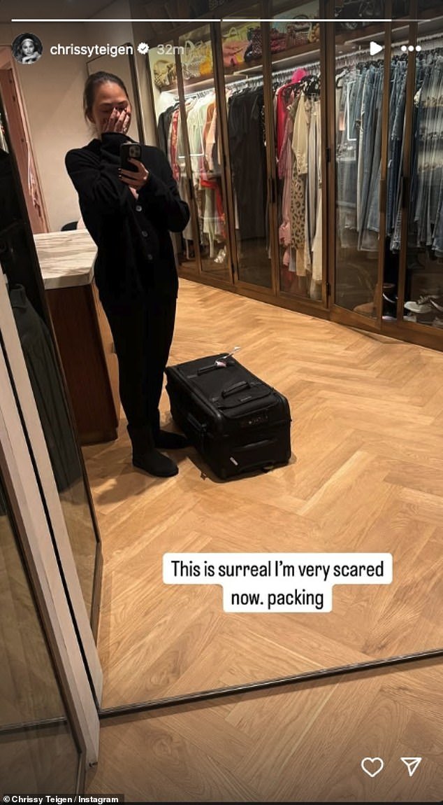 John Legend's wife, Chrissy Teigen, 39, shared a photo of herself in her walk-in closet with a black suitcase at her feet. 'This is surreal I'm very scared now. Packing,' she wrote