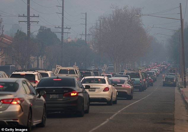 The family are among the nearly 180,000 evacuees ordered to leave their homes as at least five fires continue to burn uncontrollably; residents pictured evacuating ahead of the Kenneth Fire on January 09, 2025 in Calabasas