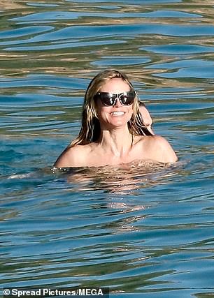 Heidi beamed ear to ear as Tom hugged her in the ocean