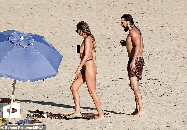 The lovebirds went back to their spot on the beach after their dip in the ocean