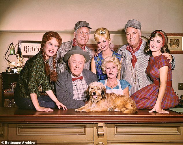 Linda Kaye Henning's (far left) most iconic role was Betty Jo Bradley on Petticoat Junction, which aired from 1963 to 1970; (pictured Petticoat Junction cast: Henning (seated), Edgar Buchanan, Bea Benaderet, Lori Saunders (seated). Back row left to right: Rufus Davis, Jeannine Riley, Smiley Burnette)