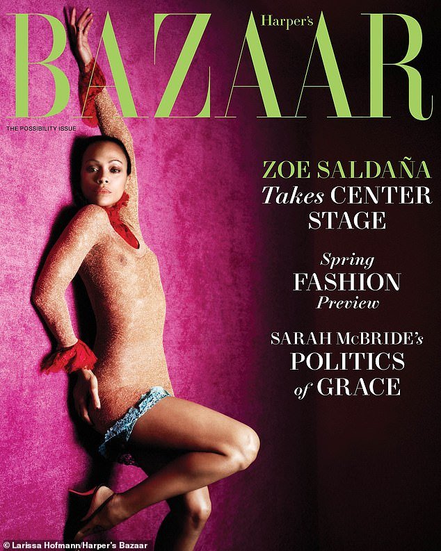 The cover image of the magazine sees Zoe lying on the group wearing a sexy see-through mini dress with a red ruffle neckline and cuffs