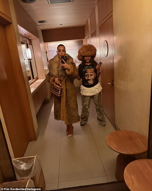 The 44-year-old SKIMS CEO opted for a fur-collared suede winter coat while her 11-year-old nepo-baby rocked an oversized fur bomber hat as they posed for a selfie in the bathroom of the seaside sushi restaurant