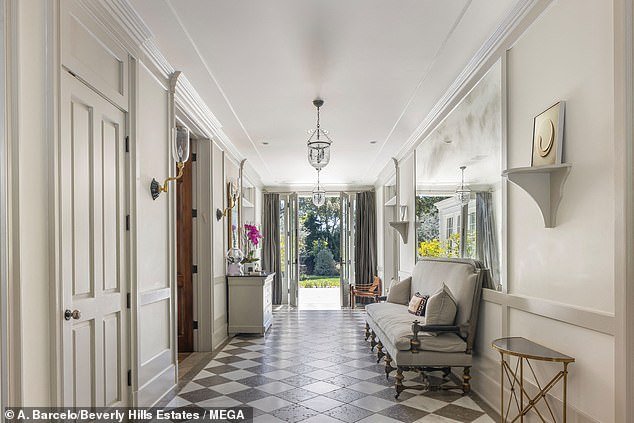 The front hallway has a black-and-white tiled floor and French doors