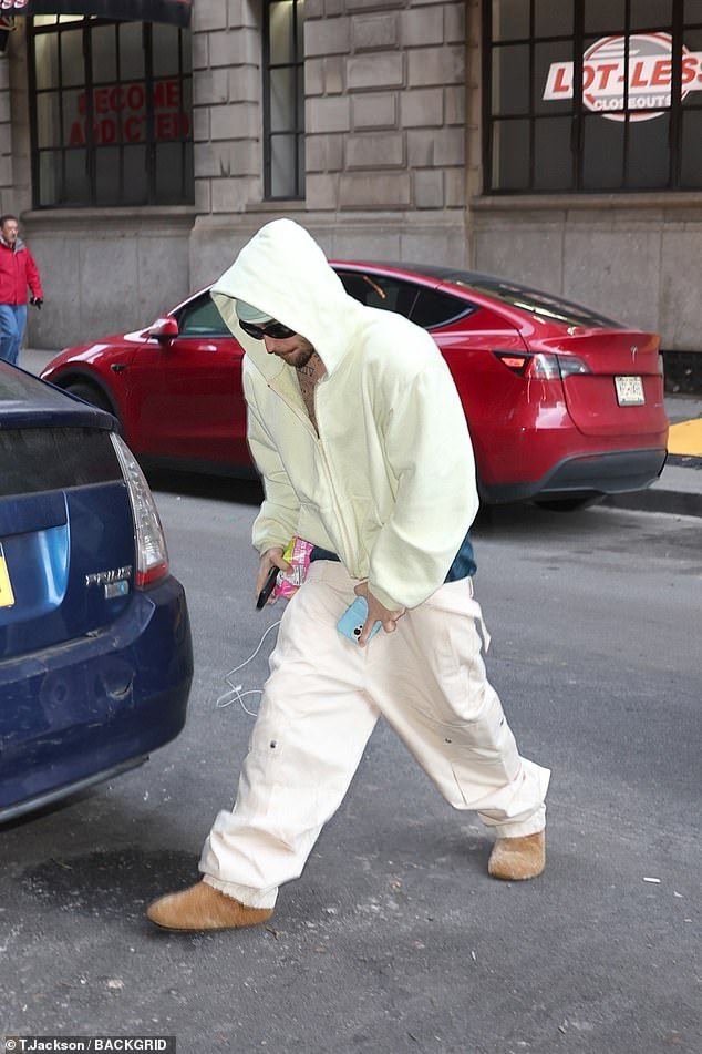 Bieber completed his spa day outfit with baggy cargo pants that sat low on his waist, exposing his navy blue boxers, and a pair of fuzzy brow slippers