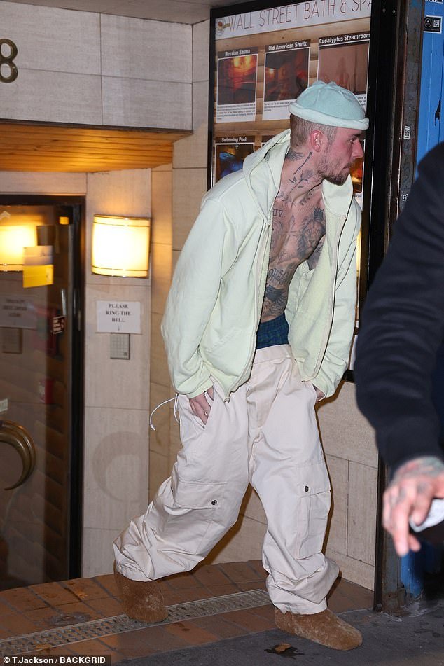 Bieber went shirtless under his sweatshirt, which he left unzipped to expose just a portion of his heavily tattooed physique