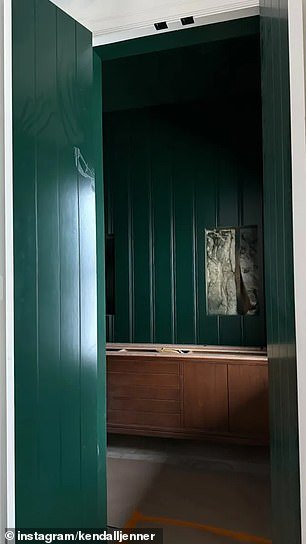 A hallway in the home included dark green wooden paneling, according to the images