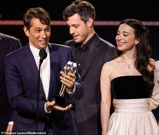 Anora's director Sean Baker (L) accepted the award with its star Mikey Madison (R) supporting him. He noted that the 'micro-budget' film cost only $6M