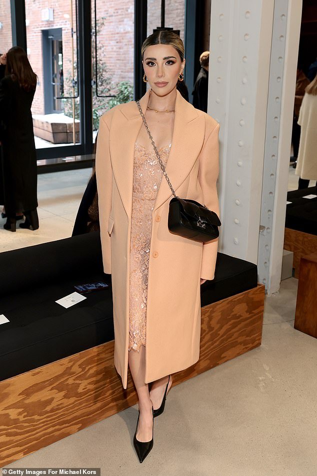 Priscila Escoto wore a peach coat over a lace dress with black heels and purse