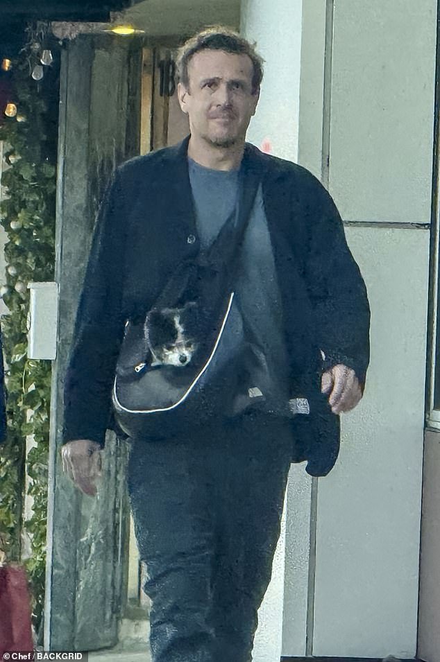 The Shrinking star , 45, looked relaxed in a gray T-shirt and charcoal pants, with a black blazer and shoes as he strolled with his lady love in the high end shopping district. The Windfall star carried his sweet black and white dog in a crossover bag