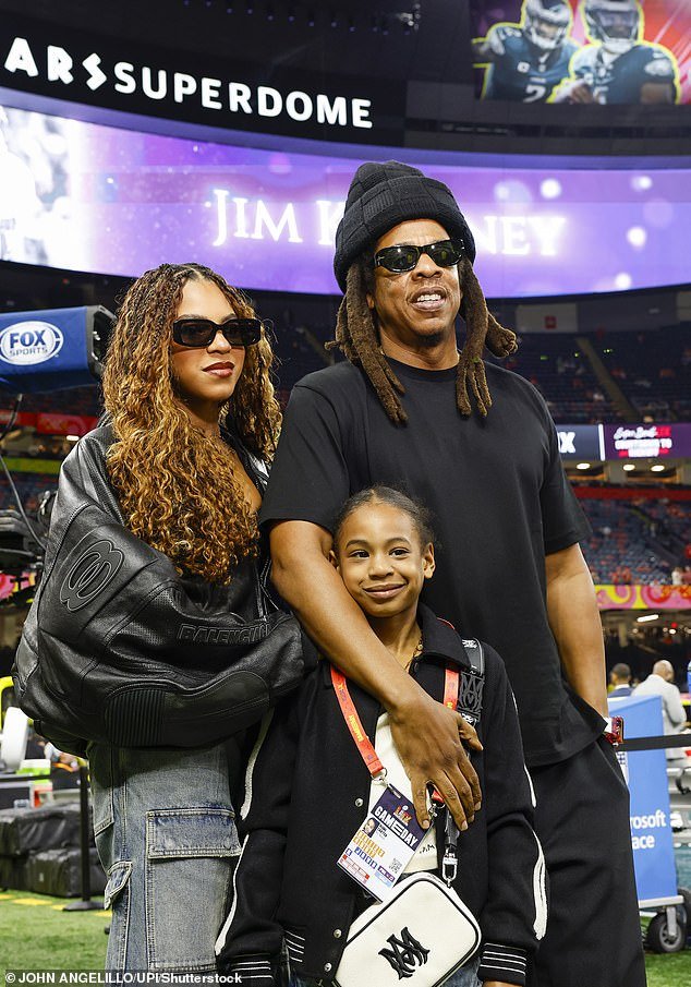 Jay-Z is seen on the sideline with daughters Blue Ivy (L) and Rumi (C) before Super Bowl LIX at Caesars Superdome in New Orleans on February 9