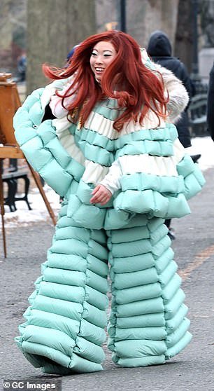 She finished her kooky look with the addition of a long, silky red wig that was styled with a side part