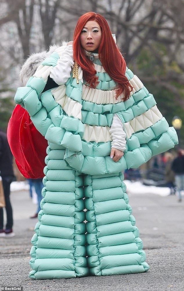 Awkwafina debuts bright red hair as she models a bizarre puffy snow suit for Arnold Schwarzenegger movie