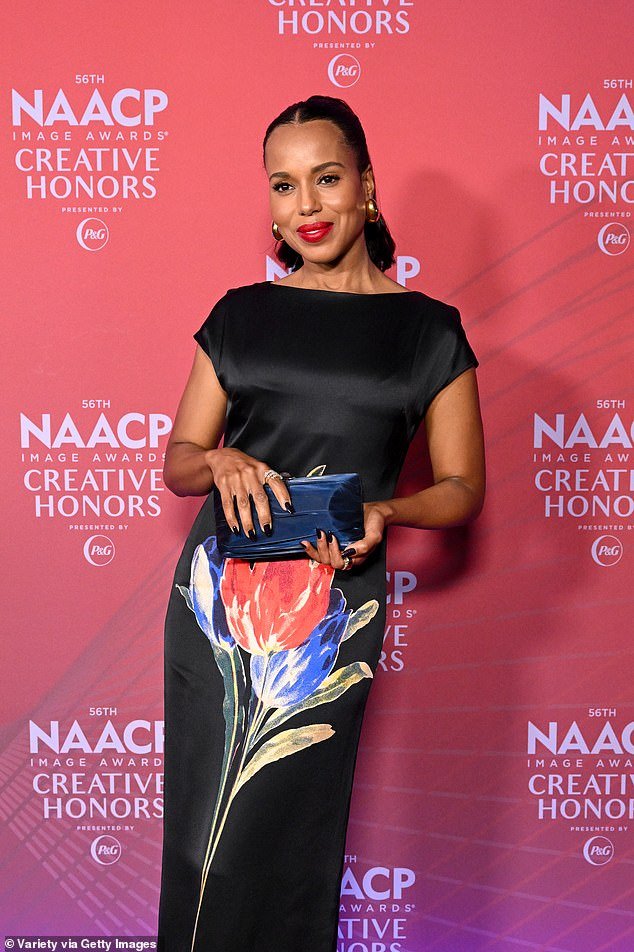 Washington, 48, commanded attention in an elegant black dress with multi-colored tulips adorning the front as she posed up a storm on the red carpet