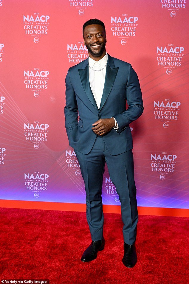 Aldis Hodge wowed in a navy suit and white dress shirt as he accessorized with a silver chain