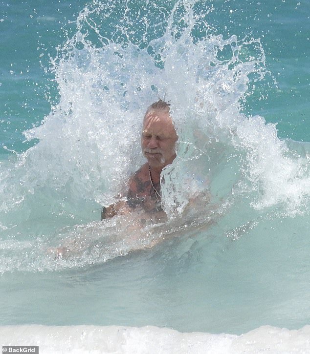 At one point, one wave made a big splash as it hit the Metallica frontman from behind