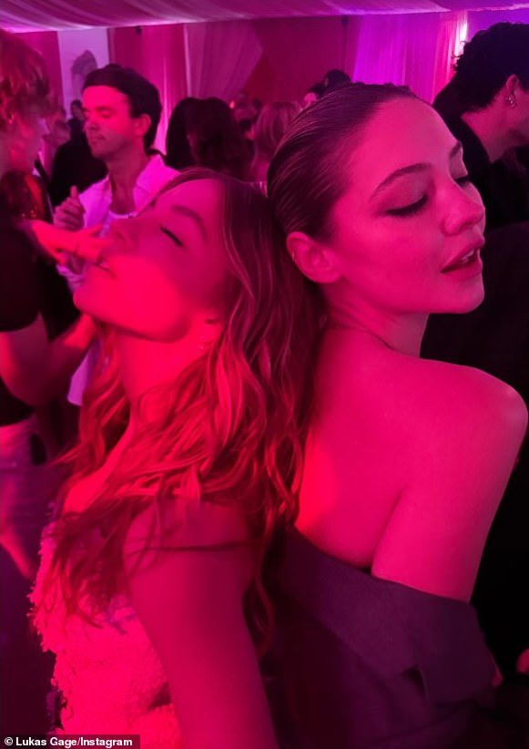 Companion actor Lukas Gage shared a snap of Sydney dancing with Outer Banks actress Madelyn Cline (R) at Paris' pink-hued party in an Instastory captioned: 'Name two hotter people'