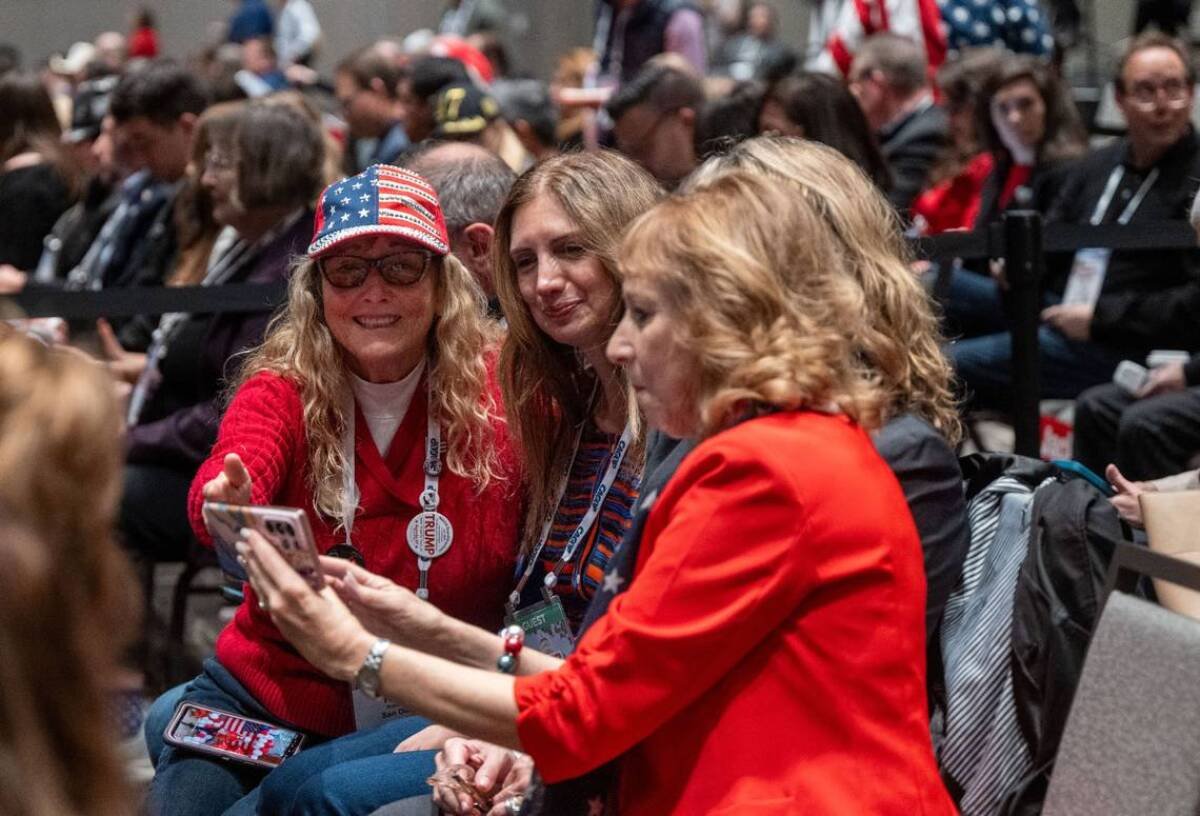 Republicans Robin Ellis, left, Sharie Abajian, center, and Barbara Moore take selfies.